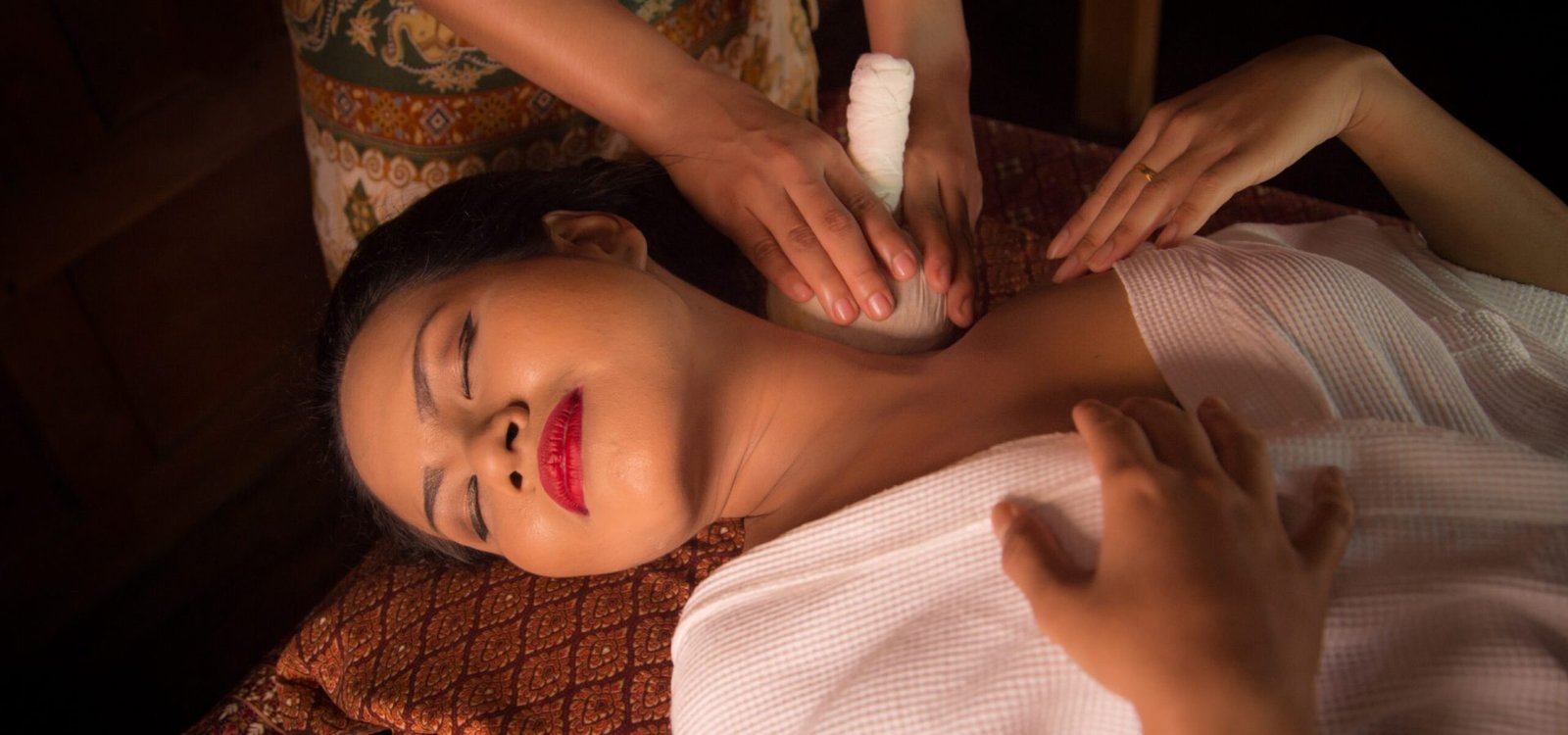 Masseur doing massage on Asian woman body in the spa salon